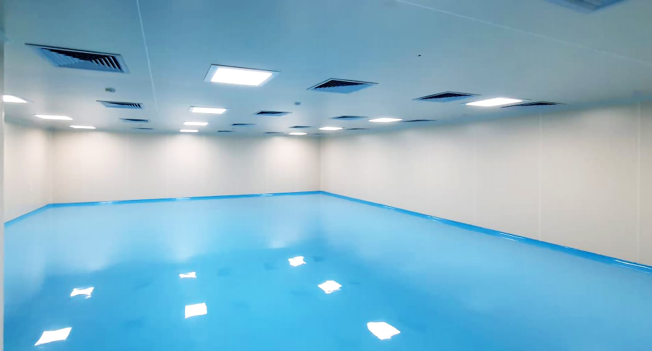 Empty glossy light-blue cleanroom interior built to a controlled ISO classification