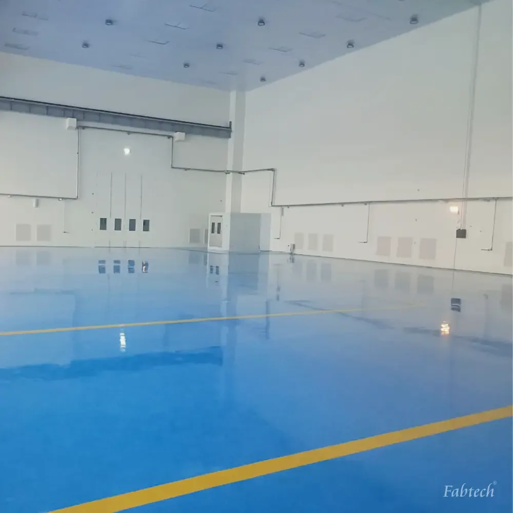 Panelled wall with low-level return grilles above a coved epoxy floor